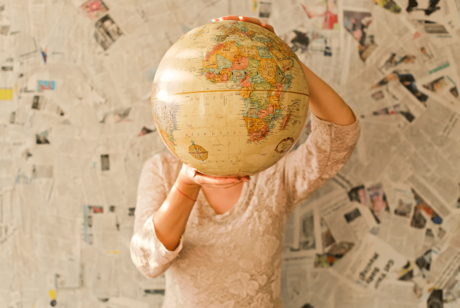 Woman holding up globe