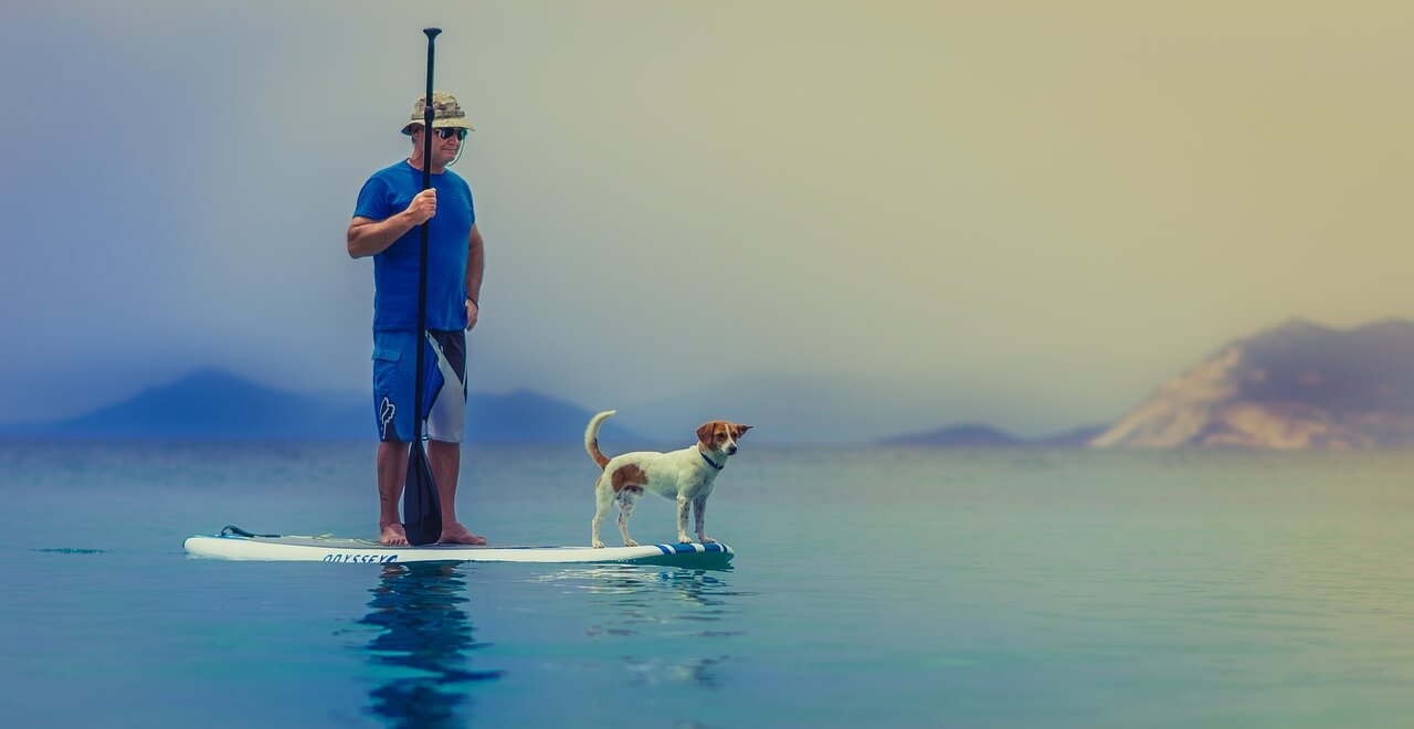 man and dog on a paddleboard