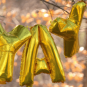 Gold balloons spelling out YAY