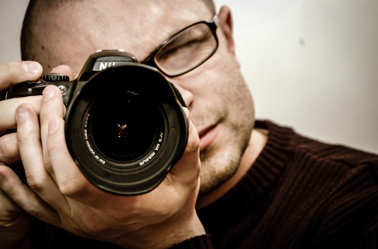 man holding camera for apartment insurance 