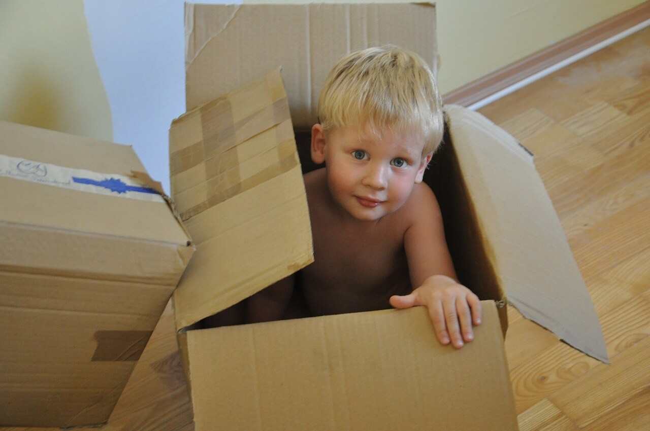 boy playing in a cardboard box